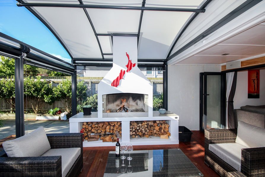 outdoor room with fireplace covered by a fresco canopy