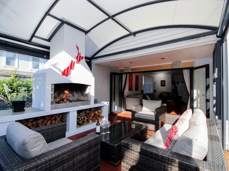 outdoor room with fireplace covered by a fresco canopy