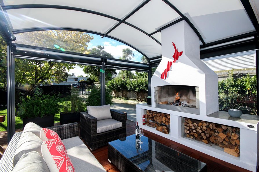 outdoor room with fireplace covered by a fresco canopy