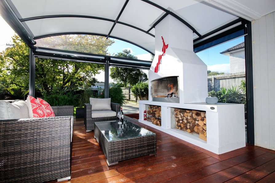 outdoor room with fireplace covered by a fresco canopy